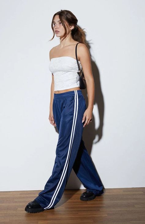 Step up your sporty style with the Tricot Wide Leg Track Pants from LA Hearts. These high-rise pants feature an elastic waistband and side hand pockets for practicality, while the side stripe details add a touch of sporty flair. The wide leg openings and baggy relaxed fit offer all-day comfort and effortless style..Solid color track pants.11.75' rise.31.5' inseam.22' leg opening.High-rise.Elastic waistband.Side hand pockets.Side stripe details.Wide leg openings.Baggy relaxed fit.Self: 100% polyester; Contrast: 100% polyester.Hand wash.Model is wearing a size small.Model measurements: 5’6.5” height, 32” bust, 23.5” waist, 35” hip.Measurements taken from a size small Styling Pajama Pants, Navy Blue Track Pants Outfit, Women’s Pants, Baggy Track Pants Outfit, Blue Track Pants Outfit, Adidas Track Pants Outfit Woman, Tracksuit Pants Outfit, Comfy Athletic Outfits, Track Pants Outfit Women