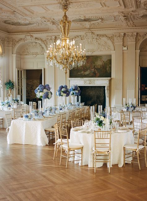 A grand ballroom setup for a wedding with long rectangular tables down the center and round on either side, with blue centrepieces Hydrangea Wedding Aesthetic, Hydrangea Ceiling, Blue And White Hydrangea Wedding, Ivory Walls, Hydrangea Wedding Decor, Wedding Hydrangeas, Blue And White Hydrangea, Rosecliff Mansion Wedding, Wedding Centerpeices