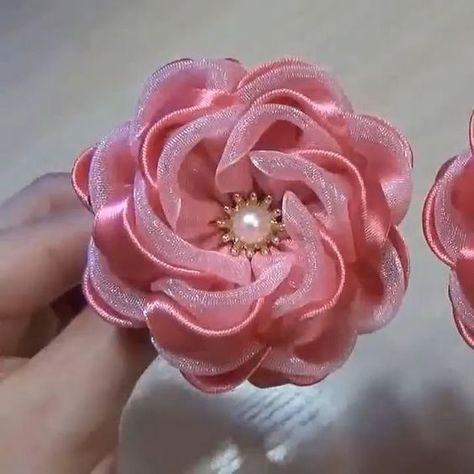 ribbon embroidery work Sewing Ribbon Flowers, Satin Flowers Diy, Diy Leather Bows, Silk Ribbon Embroidery Tutorial, Ribbon Flowers Bouquet, Dress Design Ideas, Embroidery Shirts, Ribbon Flowers Diy, Silk Ribbon Embroidery Patterns