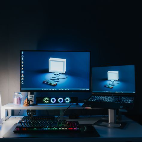 A gaming setup including one monitor and a laptop stand and RGB lighting. Gaming Setup Laptop And Monitor, Gaming Laptop Desk Setup, Monitor And Laptop Setup, Laptop Monitor Setup, Laptop And Monitor Desk Setup, Gaming Battlestation, Setup Laptop, Laptop Setup, Laptop Gaming Setup