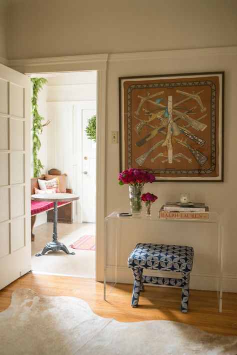 Entry hall styled by Stacie Flinner  // featuring a framed Hermes Scarf  and CB2 lucite console table Frames Hermes Scarf, Hermes Scarf Wall Art, Hermes Home Aesthetic, Framed Hermes Scarves Wall Art, Framed Scarf Wall Art, Cb2 Console, Hermes Scarf Framed, Scarf Wall Decor, Framed Hermes Scarf