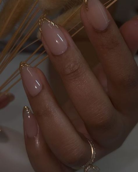 Chicago Nail Artist , danarubylee on Instagram: "One of the best collaborations. Nude, gold, and great nail care.
.
.
.
.
.
#realhotnailshit 
#realhotnailshxt 

#chicagonails #natrualnails #gelnails #nailcare #aesthetic #goldnails #almondnails #almondshapenails 

Chicago nail tech , natural nail care , gel nails , almond nails" Natural Gel X Nails Almond, Gold Nail Tips French, Gold Design Almond Nails, Cute Short Almond Nails Fall, Natural Looking Acrylic Nails Almond, Short Champagne Nails, Almond Nails Gold Designs, Clean Fall Nails, Hoco Nails Gold