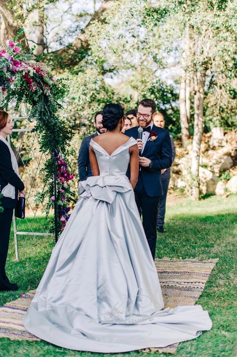 We adore this image of beautiful Los Angeles bride Coral wearing a bespoke variation of our Gabriella wedding dress. captivating bridal gown. Meters and meters of sumptuous silk duchesse satin are skilfully cut and masterfully draped over a cleverly concealed corset to create a memorable silver screen, hour glass silhouette.#angelinacolarusso #bespokebride #elegantbride #glamorousbride #designerweddingdress #hourglass #vintagestyle #corseted #corsetedbride Silver Satin Wedding Dress, Silver Wedding Dresses, Angelina Colarusso, Timeless Gown, Dramatic Wedding Dress, Wedding Dresses London, Draped Wedding Dress, Silver Wedding Dress, Glam Bride