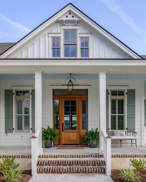 Step into Southern elegance with this custom home's inviting porch, featuring the classic haint blue ceiling and timeless Lowcountry style, perfect for welcoming guests with charm and warmth.   Discover more of our custom homes by visiting our website or following us on social media for inspiration. 🌿🏡   ____________________ #SouthernLiving #LowcountryCharm #CustomHome #HaintBlue #LoveBlufftonSC Haint Blue Porch Ceiling Southern Style, Southern Coastal Homes Exterior, Southern Living Exterior, Low Country Home Exteriors, Haint Blue Porch, Southern Home Exterior, Blue Craftsman, Haint Blue Porch Ceiling, Coastal Home Exterior