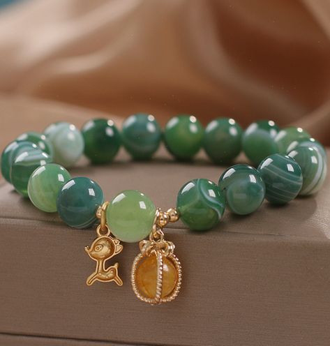 Deer means health and love. It brings happiness and longevity. is a symbol of love. Green agate represents health and vitality. It can promote blood circulation, relieve tension, bring hope and make people full of self-confidence. Keep this stunning bracelet close to discover the peaceful energy of agate in your life. Natural green agate Bead ... #Unveiling #HandmadeJewelry #Exploring #the #of #Accessories #Natures #Beauty #JewelryAddict #Allure #Fashion #Gemstone #Jewelry #of #the #Treasures Green Agate Bracelet, Green Gemstone Bracelet, Peaceful Energy, Green Beaded Bracelets, Health And Vitality, Green Bracelet, Symbol Of Love, Beads Bracelet Design, Crystal Tiaras