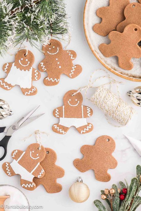 This DIY recipe for salt dough gingerbread ornaments shows you how to make these fun little Christmas crafts! Whether you decorate them or leave them blank, they're so cute and they use simple ingredients. Salt Dough Christmas Ornaments Ideas, Cardboard Gingerbread Ornaments, Salt Dough Gingerbread Ornaments, Gingerbread Salt Dough Recipe, Homemade Dough Ornaments, Homemade Gingerbread Ornaments, Gingerbread Christmas Ornaments Diy, Gingerbread Salt Dough Ornaments, Gingerbread Ornaments For Kids