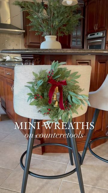 Dinning Chair Christmas Decor, Mini Wreaths On Chairs, Wreaths On Back Of Chairs, Wreaths In Kitchen, Wreath In Kitchen, Wreaths On Kitchen Cabinets, Kitchen Wreaths, Holiday Interior Design, Holiday Interior