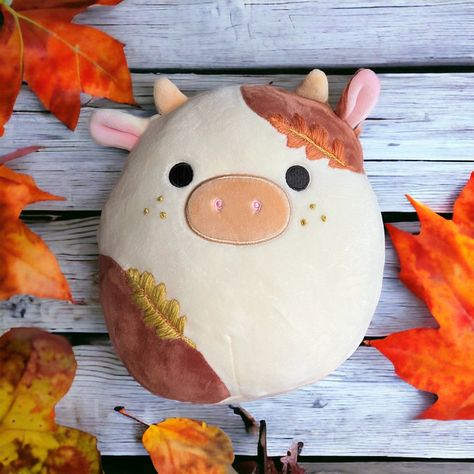 Add some autumn colors to your fall Squishmallow collection with Ronnie the Cow!  This plush has been lovingly hand-embroidered with a pretty oak leaves and adorable green freckles! This plush comes with the tush tags and hang tags included!  I also do customs! message me if you're interested! I can do pretty much any Squishmallow that is available to be purchased online!  No returns or exchanges. That being said, always feel free to reach out to me regarding problems with your order. Fall Squishmallow Aesthetic, Halloween Squishmallows Aesthetic, Squishmallows Cute, Autumn Squishmallow, Squish Mellows Big, Cow Squish Mellow, Embroidered Squishmallow, Fall Squishmallows, Aesthetic Squishmallows