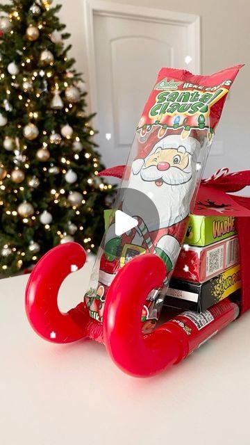 Emma Villaneda on Instagram: "🎄Pt.2 of Dollar Tree gift ideas for teachers, neighbors, coworkers, family/friends, or really anyone. 🎁🎁🎁 Sharing a fun way to gift candy! Make sure you follow for more so you don’t miss out! Materials: - 2 filled Candy Canes (Dollar Tree) - 3 candy boxes (Dollar Tree) - Chocolate Santa (Dollar Tree) - Ribbon • • • • #christmas #christmasdecor #santaclaus #sleigh #christmasgift #gingerbread #christmastime #holiday #holidaydecor #diy #craft #homedecor #design #home #interior #homedesign #interiordesign #gift #giftideas #explorepage #trending #reelvideo #newreel #art #dollartree #dollarstore #creative #santa #chocolate #candy" Candy Christmas Sleighs, Santa Sleigh Candy Diy, Christmas Chocolate Sleigh, Candy Sleigh Craft, Hershey Christmas Tree, Candy Sleigh Gift Card Holder, Christmas Candy Sled Ideas, Candy Santa Sleigh Diy, Candy Bouquet Christmas Diy