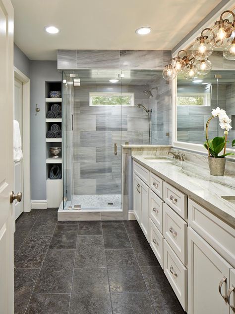 This beautiful master bathroom pulls elements from traditional and modern design styles. Recessed lighting paired with modern globe sconces -- and a small window over the shower -- ensures an always-bright space. Lena white marble, quartzite counters and limestone floors make the room feel rich and inviting. Bathroom Without Tub, Beautiful Master Bathrooms, Master Bath Design, Marble Showers, Limestone Flooring, Master Bath Remodel, Tile Flooring, Bathroom Layout, Traditional Bathroom