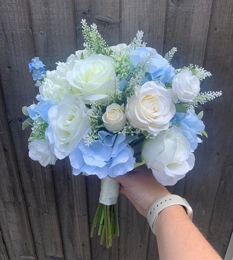 Beautiful Ivory rose and blue hydrangea bouquet Barlow Bespoke Flowers is a multi award winning florist who specialises in high quality silk blooms with 10 year experience.  Our bouquets are made using the best quality silk flowers. They look and feel extremely real and will definitely trick all your guests!  Silk flowers bouquet are beautiful choices for those that would like to keep their bouquets for years to come as it will stay looking gorgeous forever :-) "As seen in Belle Bridal Magazine" Light Blue Wedding Bouquet Brides, Hortensia Wedding Bouquet, Wedding Flowers Light Blue, Flower Bouquet Wedding Blue, Bridesmaid Flowers Bouquets, Baby Blue Flower Bouquet, Dusty Blue Centerpieces, Baby Blue Wedding Flowers, Light Blue Flower Bouquet