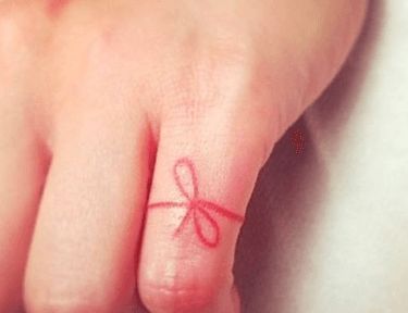 Why People Are in Love With Red String Tattoos | TipHero Red Ribbon Tattoo Meaning, Red Flag Tattoo, Red Thread Tattoo, Red String Of Fate Tattoo, Invisible String Tattoo, Red String Tattoo, Talisman Tattoo, String Tattoo, Bow Finger Tattoos