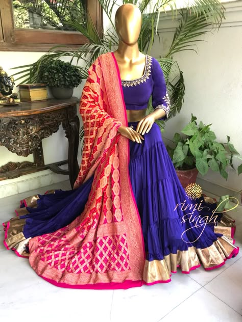 "Inspiration is some mysterious blessing which happens when the wheels are turning smoothly." Purple gypsy lehenga in chinnon chiffon, teamed with a matching crepe choli and a two shade banarasi rai bandhani dupatta with zari in pure georgette. There is dabka and kundan hand embroidery on the neckline, sleeve and waist of the lehenga. Available exclusively at Rimi Singh Studio A 999 Sushant Lok 1 Gurgaon #9818310054. Bandni Dupatta Lehenga, Bandhani Dupatta Outfit, Bandhani Dupatta Lehenga, Summer Color Combos, Bandhani Dupatta, Choli Dress, 40 Fashion Women, Wedding Lehenga Designs, Kurti Embroidery Design