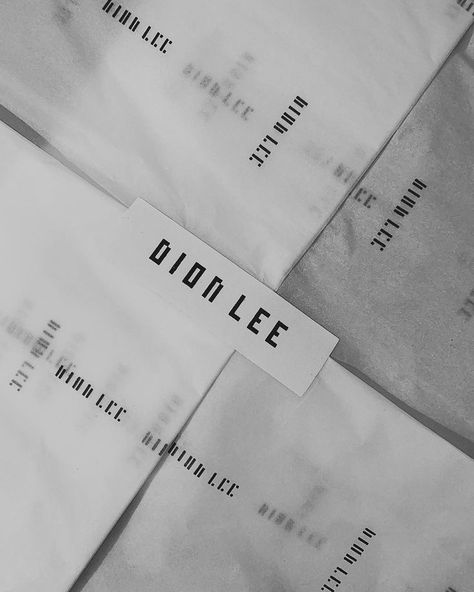 Dion Lee packaging is simplistic, with the brand logo printed in black on white stickers, bags and tissue paper. The simple packaging is visually appealing and allows for the products to stand out. Additionally, the high quality packaging adds a sense of luxury, making the customer feel special and exclusive. Logo For Bags Brand, Fashion Layout, Simple Packaging, Dion Lee, Paper Packaging, White Stickers, Feel Special, Tissue Paper, Brand Logo