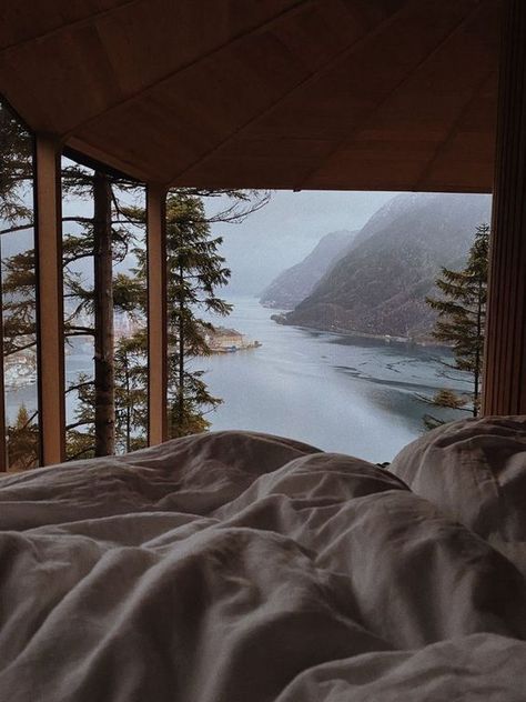 444-1 Scenic mountain and lake view from a cozy bed in a cabin, framed by wooden beams and tall pine trees. | Sky Rye Design Hygge Aesthetic, Hygge Design, Mountains Aesthetic, Scandinavian Lifestyle, Scandinavian Aesthetic, Interior Design Consultation, Norway Travel, Design Consultation, Window View