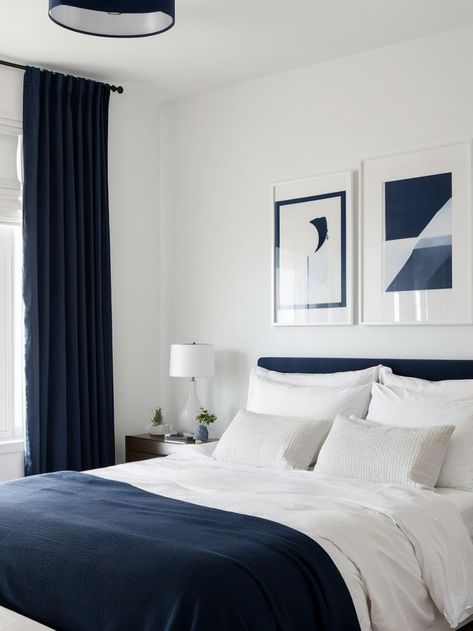 Create a bold statement by painting one wall navy blue and hang a gallery wall of artwork to add a personalized touch. Pair it with a sleek white bed frame and minimalist furniture for a modern and stylish look. Navy Blue Minimalist Bedroom, Minimalist Bedroom Blue And White, Bedroom With Navy Bed, White And Dark Blue Bedroom, Navy Bed Frame, Navy Blue Bed Frame, Royal Blue Room Ideas Bedroom, Accent Wall Artwork, Dark Blue And White Bedroom