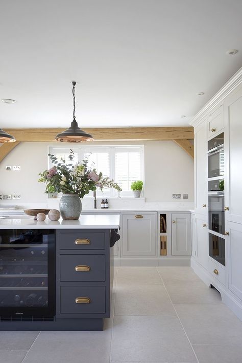 This kitchen was handmade by a local craftsman, with the cabinets painted in Little Greene ‘French Grey’ and kitchen island in Little Greene ‘Vulcan’, providing a little contrast against the Versailles limestone kitchen flooring. A subtle and beautiful stone, the Versailles limestone tile has a softly aged finish yielding a pale wash tone with delicate fossil details and markings. Little Greene French Grey, Barn Conversion Interiors, Limestone Tiles, Oak Frame House, Oak Framed Buildings, Loft Kitchen, Flagstone Flooring, Limestone Tile, Frame House