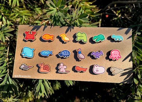 **Because the wood is a natural material, the colors, grain, and size will vary in each pin and may not perfectly match the pictures! Adorable and silly animal/creature wooden pins designed by us, perfect for your jackets, purse, backpack, tote bag, lanyards and more! ~2.5 cm wide wooden pin (exact sizes will slightly vary between pins) - Option of orange star-shaped rubber backing OR an extra secure locking pin mechanism (pins won't detach unless you lift the pin mechanism, preventing pins from falling off and getting lost from heavy use) - Custom printed on responsibly sourced, fast-growing woods, with a maple veneer. Wooden pins use 20 to 24 times less energy to produce than enamel pin badges! Shop policies:  - we use eco-friendly packaging <3 - please feel free to message us with any q Where To Put Pins, Cool Enamel Pins, Funny Enamel Pins, Pins On Jacket, Pins On Backpack, Pin Button Design, Backpack With Pins, Badge Accessories, Wooden Pins