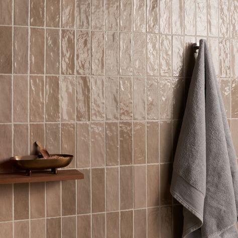 Refresh any space with our Portmore Taupe 3x8 Glazed Ceramic Tile, a versatile, classic subway in a go-to neutral shade that suits any design style. Portmore’s appearance—speckled, uneven, and artisanal—lends it a rustic, yet sophisticated vibe. With its subtle, Moroccan influence, this glazed tile will transform your residential or commercial walls with long-lasting, statement-making beauty. The Portmore collection of glazed, ceramic tiles is inspired by the colors and exquisite tilework found Taupe Zellige Tile, Brown Subway Tile Bathroom, Tan Bathroom Tile Ideas, Organic Bathroom Tile, Light Brown Shower Tile, Mauve Tile Bathroom, Mid Century Shower Tile, Tan Subway Tile Bathroom, Brown Shower Tile Bathroom