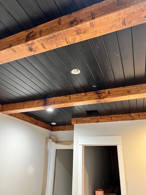 Wood Beam Basement Ceiling, Basement Wood Beams, Low Ceiling Cabin Ideas, Wood Beam Living Room Ceiling, Black Tin Ceiling Ideas, Black Ceiling Vaulted, Black Ceiling Farmhouse, Half Basement Remodel, Patio With Wood Beams