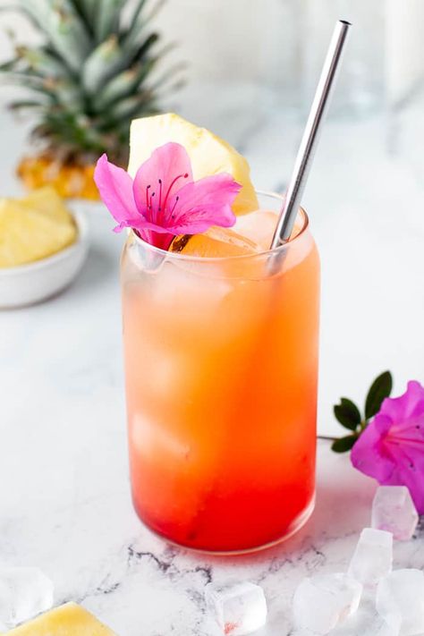 My go-to drink for this spring and summer is this Pineapple Orange Rum Punch. Transcend yourself to the tropical islands even when sipping on this drink in your kitchen. Tropical Fruit Cocktail, Orange Themed Cocktails, Tropical Cocktail Aesthetic, Pink And Orange Drink, Pineapple Summer Drinks, Tropical Food For Party, Easy Tropical Cocktails, End Of Summer Cocktails, Refreshing Cocktail Recipes