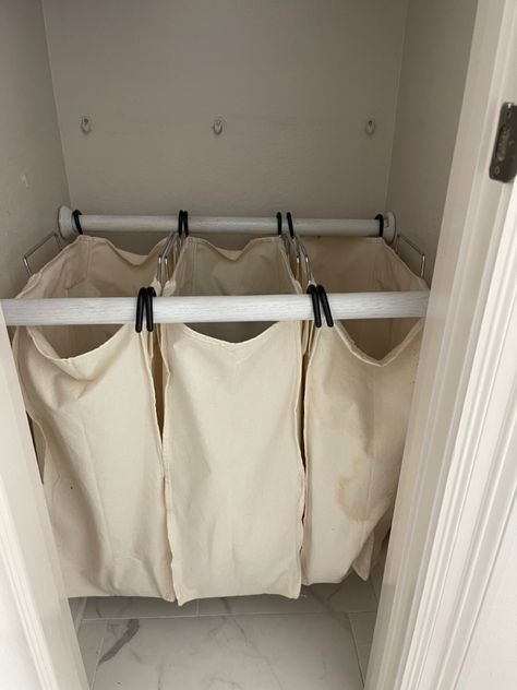 I took these laundry bags from a metal laundry cart. I used closet wooden rods and wall attachments to have a hidden laundry hamper in the linen closet in the master bathroom. Hanging Laundry Bag Diy, Diy Laundry Bag Hanging, Linen Closet With Laundry Hamper, Bathroom Laundry Hamper Ideas, Hanging Laundry Aesthetic, Laundry Solutions For Small Spaces, Laundry Hampers Ideas, Laundry Hamper In Closet, Dirty Laundry Storage Ideas