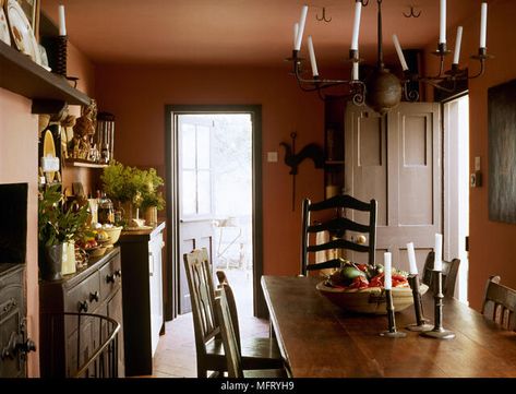 Country terracotta dining room wooden table chairs wrought iron chandelier Interiors rooms traditional period features furniture rustic oak Stock Photo Terra Cotta Dining Room, Terracotta Dining Room, Wrought Iron Chandelier, South Street, Wooden Table And Chairs, Furniture Rustic, Iron Chandelier, Wrought Iron Chandeliers, Table Chairs