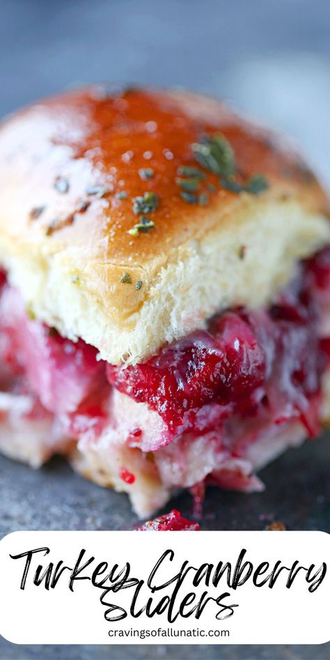 A close up image of a turkey cranberry slider on a dark counter. Cranberry Turkey Panini, Easy Sandwich Sliders, Cranberry Sandwich Spread, Turkey Leftover Sliders, Best Turkey Sandwich Recipes, Turkey Meals Leftover, Turkey Dressing Sandwiches, Turkey Leftover Sandwiches, Thanksgiving Leftover Sliders