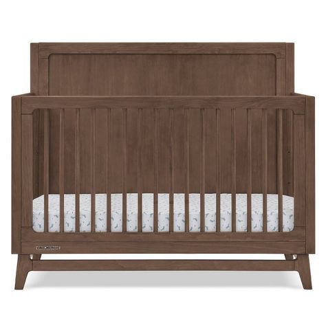 The mid-century design of the Spencer 6-in-1 Convertible Crib by Delta Children anchors nurseries with timeless style. You’ll love the solid headboard, round spindles and angled feet. Designed with everlasting style in mind, this versatile crib grows with your child, it features three mattress heights, and converts into a toddler bed, daybed, sofa and full size bed with and without footboard (Daybed/Sofa Rail included; Toddler Guardrail #W100725 and Full Size Wood Bed Rails #0050 sold separately Walnut Nursery Furniture, Brown Nursery Furniture, Boy Nursery Furniture, Headboard Round, Hippie Nursery, White Gate, Navy Nursery Boy, Wooden Crib, Brown Crib