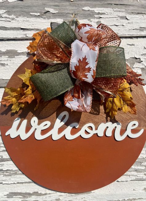 🍂✨ Welcome the cozy vibes of fall with our charming round door sign! Perfect for adding a touch of autumn warmth to your home, this beautifully crafted piece features stunning seasonal colors and inviting designs. 🧡🍁 Transform your entryway into a festive haven and greet your guests with style! 🌟 👉 Tap to shop now and make your front door the talk of the neighborhood! 🏡🍂 #FallDecor #WelcomeHome #AutumnVibes Round Wooden Door Hangers Diy, Thanksgiving Door Hangers, Fall Wooden Door Hangers, Fall Door Sign, Fall Front Door Decor, Door Hanger Fall, Fall Door Hanger, Door Hangers Diy, Rustic Door