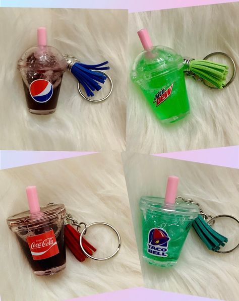 Mini Soda Cup Keychain! There is liquid and fake ice chips inside. The color will settle after a while, so you must shake it for it to look normal again This unique keychain features a miniature representation of a refreshing soda drink. The intricate design and use of liquid material make it a beautiful addition to any keychain collection. Handmade with care, this keychain is perfect for those who appreciate the artistry that goes into creating small accessories. The food & drink theme make it a great gift for soda enthusiasts or anyone who loves quirky and fun accessories. Suitable for teens, men and women, this Soda Keychain is sure to be a conversation starter. Drink Keychain, Liquid Keychain, Cup Keychain, Coffee Keychain, Starbucks Birthday, Candy Theme Birthday Party, Ice Chips, Keychain Collection, Soda Cup