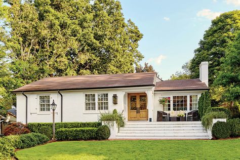 The Front Steps Create Balance - A Dramatic Ranch House Renovation - Southernliving. The 19-foot-wide stairs run all the way to the edge of the house. This design trick fills the void beneath the wide window on the right and creates the feeling of a traditional front porch without altering the ranch's straight roofline. Ranch Style Homes Exterior, Ranch Renovation, Ranch House Remodel, Exterior House Renovation, Ranch House Exterior, Ranch Remodel, Homes Exterior, Ranch Exterior, Brick Ranch