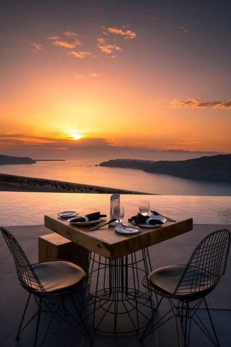 A table with 2 chairs. In the background we see the sun setting creating beautiful colors in the sky Greek Vacation, Eastern Mediterranean, Honeymoon Spots, Modern Deco, Fate Stay Night Anime, Alaska Travel, Dream Holiday, Hello Beautiful, Relax Time