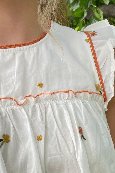 Romantic and cottage core vintage inspired cream embroidered floral printed ruffle top with round neckline, ruffle flounce accents on sleeves and hem, with crochet lace accent, and charming rust color floral print throughout. Back keyhole with button closure. Fall vibes! Round neckline Floral printed ruffle top 100% Cotton, 100% lining Cottage Core Aesthetic Clothes, Countryside Outfit, Cottage Core Clothes, Cottage Core Vintage, Cottage Core Style, Core Wardrobe, Laced Up Shirt, Sewing Design, Floral Outfit