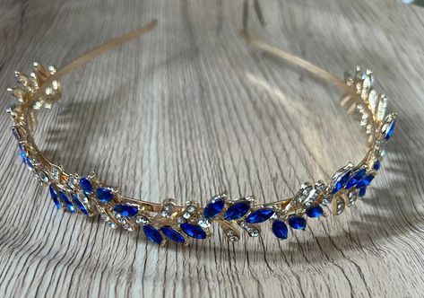 Add a touch of elegance to your outfit with this stunning headband tiara. The dark blue and gold colour and sparkling crystals makes the perfect accessory for a formal occasion.  The headband style makes it comfortable  to wear all day long. Make your special day memorable with this gorgeous tiara.  One size fits all. Blue And Gold Tiara, Dark Blue Jewelry, Bling Hair, Blue Hair Accessories, Royalty Fashion, Headpiece Diy, Hair Accessories Wedding, Preppy Jewelry, Gold Tiara