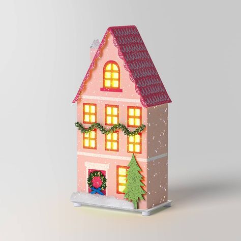 Beautifully illuminate your Christmas display with this Lit LED Paper House Christmas Village Building from Wondershop™. Made of paper, this pink Christmas house with multiple windows features Christmas decorations and lights for a warm, festive glow. Its flat base and LED lighting make it great for placing on your mantel or console table, either alone or paired with other holiday decor. Welcome to the Wondershop™. Christmas Village Collections, Glitter Houses, Paper House, Glass Jar Candles, Fur Throw Pillows, Indoor Christmas Decorations, Indoor Christmas, Fabric Houses, Pink Houses