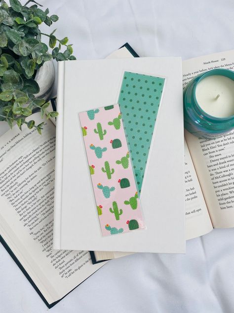 "Handmade laminated bookmark. Front features drawn cactuses on a pink background with the reverse featuring green and teal dot pattern. Dimensions of bookmark: 2\" x 6\" **Please note because of the way the bookmarks are cut the prints do slightly vary. The bookmark you receive may not look exactly like the ones you see here.**" Creative Bookmarks Design, Bookmarks Design, Bookmark Design, Handmade Bookmarks, Creative Bookmarks, Sticker Ideas, Gifts For Bookworms, Cactus Print, Bookmarks Handmade