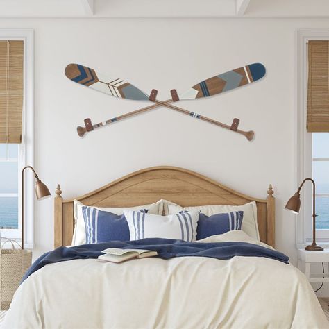 Decorative oars in coastal bedroom. Perfect combination of style and originality. Find our selection of hand painted canoe paddles at: www.ropesandwood.com Oars On Wall Decor, Canoe Paddle Decor, Painted Canoe, Painted Oars, Lakehouse Bedroom, Paddle Decor, Oar Decor, Painted Paddles, Lake House Bedroom