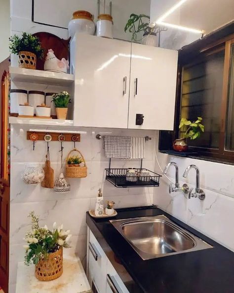 This kitchen also features a convenient solution for air-drying dishes. However, the drying rack is mounted to the wall instead of over the sink. Image credit: INSTAGRAM @HOMEVISIONTOREALITY Above The Kitchen Sink, Sink Drying Rack, Sink Organization, Above Sink, Above The Sink, Small Kitchens, Over The Sink, Drying Rack, Daily Activities