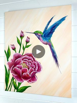 Hummingbird and Flower Painting | Here is a colorful step by step painting tutorial of a hummingbird and peony flower 🎨🌸 This picture is perfect for spring and just in time to paint for... | By Emily Seilhamer Art | Let's paint a hummingbird and a
flower today. This one has been on my list for a while. I'm
going to use sixteen by 20 stretch canvas to give us a
little bit more room to do detail and I'm keeping the
background color simple. Just orange and white. If you do too
much orange, you can blend it in with a lot of white. That's
what I'm doing to keep it really soft and I did diagonal
strokes across my entire canvas and then make sure you dry it
for the next step. Now, for the main flower, I'm going to start
with a size three round brush and take some pink with red
just to get a mid Hummingbird Colors, Hummingbird And Flower, Step Stones, Round Brush, Humming Bird, Step By Step Painting, Next Step, The Next Step, Peony Flower