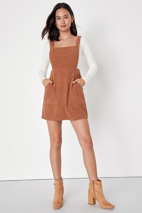 The Lulus Embracing Autumn Brown Corduroy Pinafore Mini Dress is the overall winner for the cutest look this season! This trendy pinafore dress has a velvety corduroy composition that shapes an apron-style bodice, a square neckline, and wide straps. A banded waist tops a figure-skimming mini skirt with front porkchop pockets. Exposed silver back zipper. Layer with a mock neck top for a retro 'fit! Fit: This garment fits true to size. Length: Mid-thigh. Size medium measures 32.5" from shoulder to Corduroy Dress Outfit, Overall Dress Outfit, Trendy Outfits Boho, Melbourne Winter, Corduroy Pinafore, Corduroy Pinafore Dress, Neutral Dresses, Corduroy Overall Dress, Cute Casual Dresses