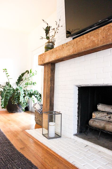 Eclectic Minimalism in Park City (Part 1) | Shining on Design White Fireplace Brick With Wood Mantel, Wood Framed Fireplace Surround, Fireplace With Natural Wood Mantel, Wood Beam Fireplace Surround, White Fireplace Remodel, White Tile Fireplace Wood Mantle, Wood Frame Around Fireplace, Bohemian Fireplace Ideas, Love Edge Fireplace Mantle