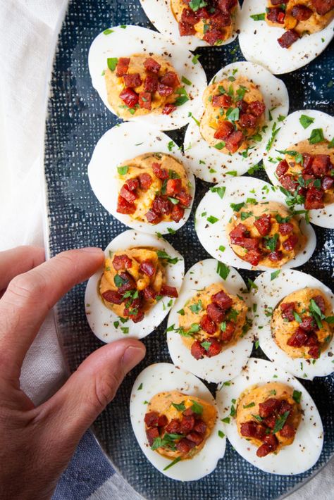 A hand reaching for Chorizo deviled eggs. Chorizo Deviled Eggs, Devilish Eggs, Angel Eggs, Deviled Egg Recipes, Pickled Deviled Eggs, Devil Eggs, Quail Recipes, Keto Deviled Eggs, Devilled Eggs Recipe Best