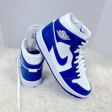 Jordan Brand Is Added A Brand New Colorway Of Their Air Jordan 1 Mid That Comes Dressed In A White And Hyper Royal Color Scheme. This Air Jordan 1 Features A White Tumbled Leather Upper Paired With Hyper Royal Blue Smooth Leather Overlay. Perforated Detailing On The Toe Box, Wings Logo On The Ankle And Jumpman Branding On The Tongues And Insole. Finishing Off The Design Is A White Midsole With A Blue Rubber Outsole. Jordans Nike Air, Blue High Top Nikes, Blue And White Air Jordans, Jordan 1 Bleu, Royal Blue Nike Shoes, Womens Jordans Sneakers, Jordan 1 Blue And White, Royal Blue Jordans, Blue Air Jordans