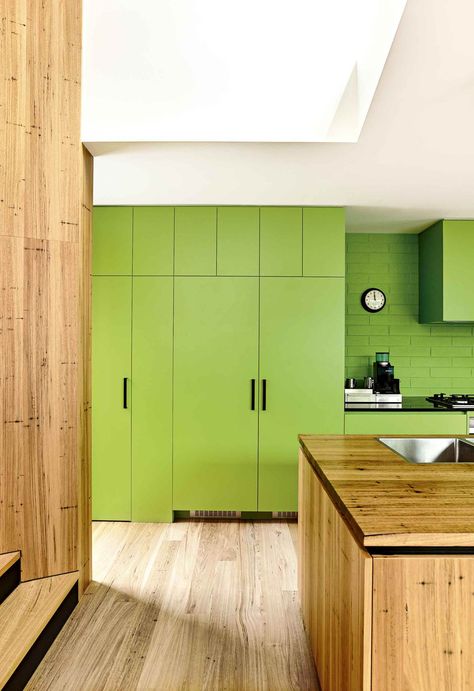 A light coloured timber bench and floorboards help to balance the intensity of the lime green cupboards and painted brick wall in this family friendly bungalow. Owners Ri and Nick were determined to have the laminate green kitchen cabinets in the heart of their home. Lime Green Paint Color, Kitchen Cabinet Color Ideas, Yellow Cabinets, Bold Kitchen, Blue Kitchen Cabinets, Blue Photography, Green Kitchen Cabinets, Timber Panelling, Sleek Kitchen