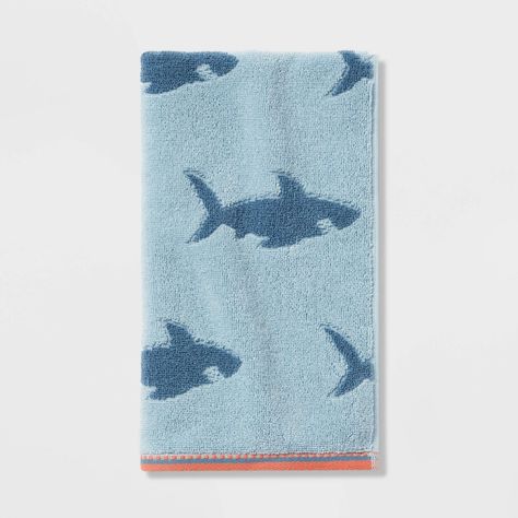 Bring function and style to any bathroom with this Shark Hand Towel from Pillowfort™. Made from 100% cotton for a soft feel and absorbency, this decorative hand towel comes in handy for drying off their face or hands. Designed in a blue hue, it features a jacquard-knit construction with shark silhouettes in a deeper shade of blue and contrasting orange trim for visual appeal. Shark Nursery Baby Boy, Kids Shark Bathroom, Shark Home Decor, Shark Kids Bathroom, Shark Boys Room, Shark Room Decor, Shark Bathroom Decor, Fish Items, Ocean Theme Bathroom