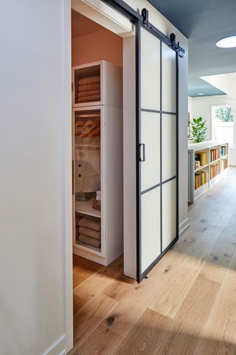 The sliding barn door connects the laundry room to the rest of the home’s second floor. A bunk room, guest bedroom, guest bathroom, main bedroom suite and a creative music room are the other spaces on the upper level of this one-of-a-kind urban escape. Unique Laundry Room Doors, Laundry Room Sliding Door, Bathroom Main, Laundry Room Pictures, Hgtv Designers, Fall Front Porch Ideas, Laundry Room Doors, Hgtv Dream Home, Tempered Glass Door