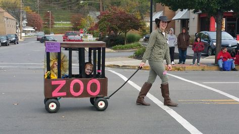 Zoo cage (built over wagon) with a Lion, Gorilla, and Zoo Keeper Family Zoo Animal Costumes, Wagon Zoo Cage Halloween, Zoo Animal Family Costumes, Wagon Cage For Halloween, Zoo Theme Halloween Costumes, Zoo Keepers Family Costume, Zoo Animals Halloween Costumes, Zoo Keeper And Animal Costume, Zoo Costumes For Family