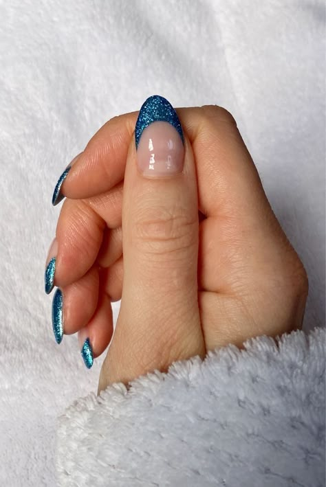 Colored French Tip Nails Winter, Blue Nails Ideas Sparkle, Blue Glitter Nails French Tip, Navy Blue Glitter French Tip Nails, Blue Sparkle Nails French, Blue Sparkle Tip Nails, Sparkly Blue Tip Nails, Blue Sparkly Tips Nails, Blue Glitter French Tip Nails Almond