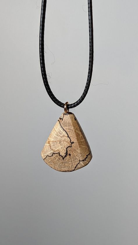 This is a handcrafted wood pendant made from locally sourced and naturally fallen wood. I suspect it's beech wood as that's the primary species in my area, but I'm not entirely sure since I only collect it once it's already fallen :) This pendant features a beautiful and unique pattern caused by the natural decay of wood, as well as a hand sculpted design as a juxtaposition to the organic shapes of the spalting. The result is a timeless, breathtaking and organic piece of jewelry that suits women Wood Jewelry Diy, Wood Jewelery, Wood Artwork, Wooden Accessories, Diy Bracelets Patterns, Wooden Necklace, Wooden Pendant, Wood Pendant, Handcrafted Wood